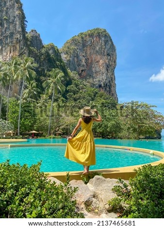 Woman tourist in yellow dress and hat traveling on Railay beach, Krabi, Thailand. vacation, travel, summer, Wanderlust and holiday concept Royalty-Free Stock Photo #2137465681