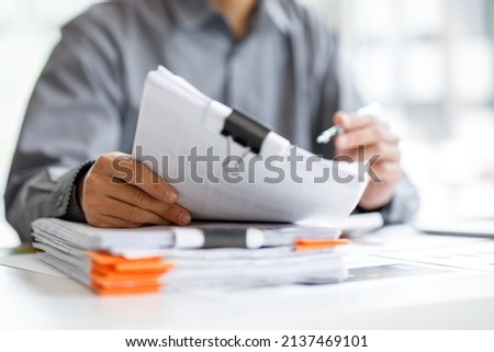 Business Documents, Auditor businesswoman checking searching document legal prepare paperwork or report for analysis TAX time,accountant Documents data contract partner deal in workplace office Royalty-Free Stock Photo #2137469101