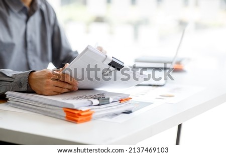 Business Documents, Auditor businesswoman checking searching document legal prepare paperwork or report for analysis TAX time,accountant Documents data contract partner deal in workplace office Royalty-Free Stock Photo #2137469103