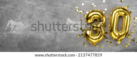 Yellow foil balloon number, number thirty on a concrete background. 30th birthday card. Anniversary concept. for anniversary, birthday, new year celebration. banner, copy space. Royalty-Free Stock Photo #2137477859