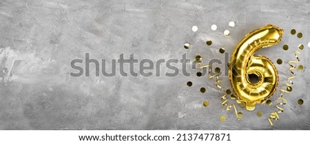 Yellow foil balloon number, number six on a concrete background. Birthday card with lettering 6. Anniversary concept. for anniversary, birthday, new year celebration. banner, copy space. Royalty-Free Stock Photo #2137477871