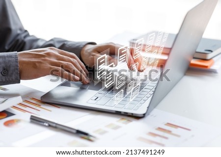 Businessman signs an electronic document on a digital document on a virtual laptop computer screen,Paperless workplace idea, e-signing, electronic signature, document management.