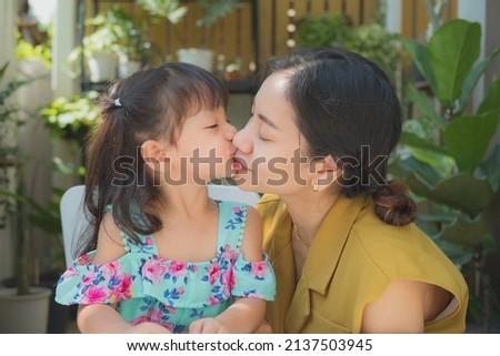 Asian mother and child girl  kissing and hugging , Healthcare and medical love lifestyle mother's day concept ,Happy loving family. 