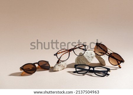 Sunglasses and glasses sale concept. Trendy sunglasses on beige background. Trendy Fashion summer accessories. Copy space for text. Summer sale. Optic store discount poster. Minimalism Royalty-Free Stock Photo #2137504963
