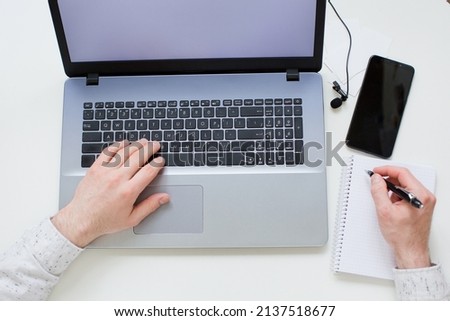 Hands on lapton, working time. Work concept. Laptop, smartphone and lapel microphone on a white background