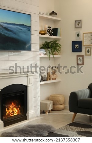 Cozy living room interior with comfortable sofa and decorative fireplace