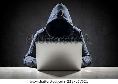 Computer hacker stealing data from a laptop concept for network security, identity theft and computer crime Royalty-Free Stock Photo #2137567521