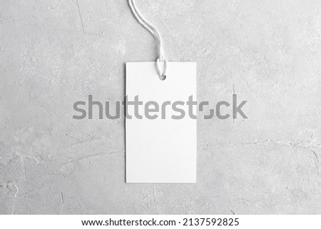 Rectangle white tag mockup with white cord, close up. Blank paper rectangular price tag mockup isolated on grey background with copy space, Sale and Black Friday concept Royalty-Free Stock Photo #2137592825