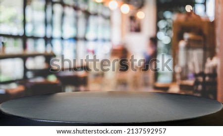 Empty wooden table and blurred background of abstract in front of restaurant or coffee shop for display of product or for montage.