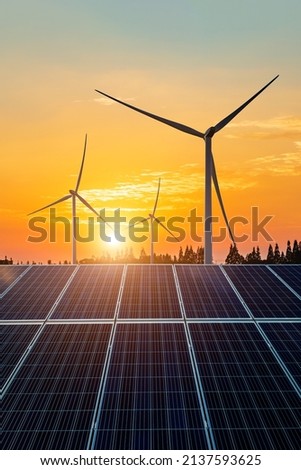 Wind turbines and solar panels at sunset. renewable energy concept. Royalty-Free Stock Photo #2137593625