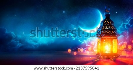 Ramadan Kareem - Moon And Arabian Lantern With Blue Sky At Night With Abstract Defocused Lights - Eid Ul Fitr Royalty-Free Stock Photo #2137595041