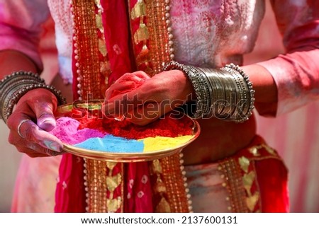 India, 17 March, 2022 : Holi festival, Young Indian woman holding red powdered color on a plate on the occasion of the Holi festival. Royalty-Free Stock Photo #2137600131