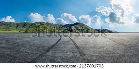 Empty asphalt road and mountain nature scenery under blue sky. Road and mountains background.