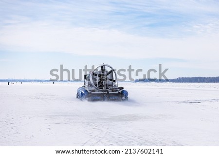 Ice transport. hovercraft. Ice on the surface of the Volga River, ice floe, crack, snow, reflection. blue sky. Horizon. Horizontal.