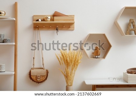 Stylish hanger for keys on white wall in hallway Royalty-Free Stock Photo #2137602669