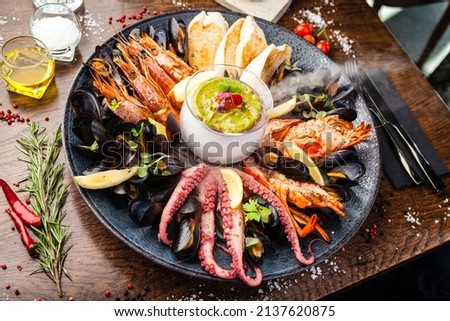 Seafood platter for 2-4 persons. Lobster, octopus, blue mussels, Argentina king prawns, tuna tartare. Delicious healthy traditional food closeup served for lunch in modern gourmet cuisine restaurant Royalty-Free Stock Photo #2137620875