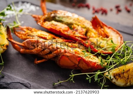 Lobster with flavored butter. Herb butter, lemon. Delicious healthy traditional food closeup served for lunch in modern gourmet cuisine restaurant Royalty-Free Stock Photo #2137620903