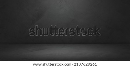 Empty dark grey cement loft wall room interiors studio background well editing montage display products on floor stage advertising and text present on free space concrete backdrop  