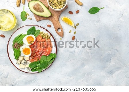 Ketogenic diet breakfast. salmon, avocado, cheese, egg, spinach and nuts. Healthy fats, clean eating for weight loss. banner, menu, recipe place for text, top view,