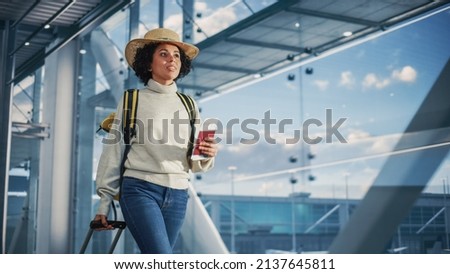Airport Terminal: Black Woman Holds Ticket, in a Hurry is Late and Runs Through Airline Hub to the Gates and to Her Airplane. African American Female Running for Flight to Vacation Destination Royalty-Free Stock Photo #2137645811