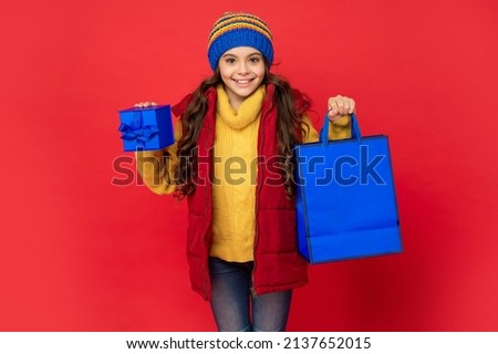 seasonal christmas sales. glad teen girl in with box. boxing day. present and gifts buy.