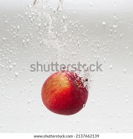 The apple falls into the water .