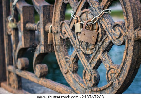 Padlock on old bridge as a sign for eternal love. Selective focus.