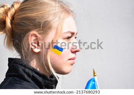 Portrait of Ukrainian teen blond hair girl with flag of Ukraine,patriotic symbol. Pray for Ukraine,war 2022 Russia attacked Ukraine