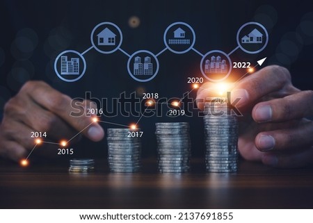 Digital chart on coins stock market investment for real estate Royalty-Free Stock Photo #2137691855