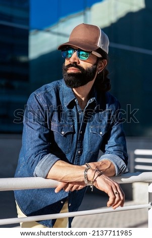 Stylish bearded man in city