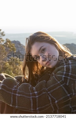 Portrait of smiling young woman wearing sweetheart outdoors. Pretty teenage girl resting in countryside. Outdoor weekend concept