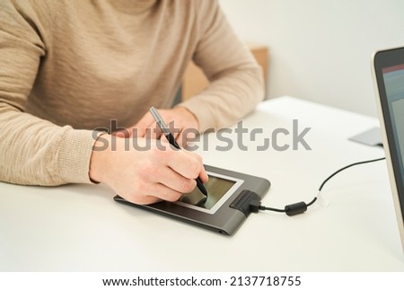 a man signing on a digital tablet