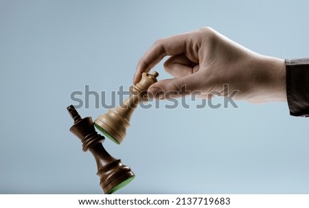 Player defeating his opponent and winning a chess game, leadership and power concept Royalty-Free Stock Photo #2137719683