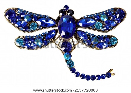A blue dragonfly jewelry on white background, isolated. Royalty-Free Stock Photo #2137720883