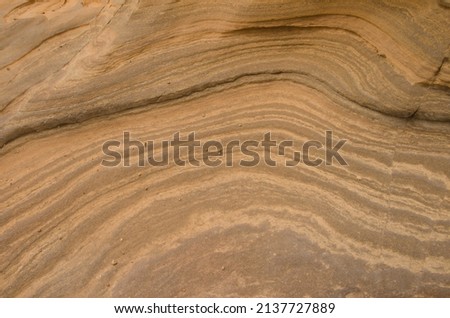 Rock surface showing different strata. Montana Clara. Integral Natural Reserve of Los Islotes. Canary Islands. Spain. Royalty-Free Stock Photo #2137727889