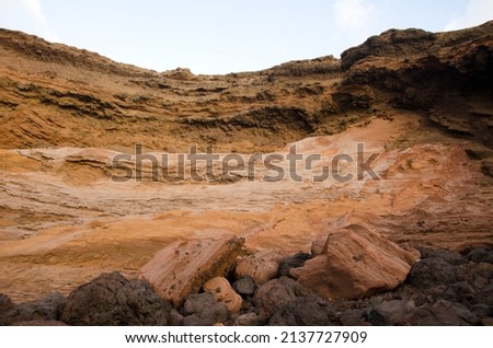 Cliff and rocks. Caleton Oscuro. Montana Clara. Integral Natural Reserve of Los Islotes. Canary Islands. Spain. Royalty-Free Stock Photo #2137727909