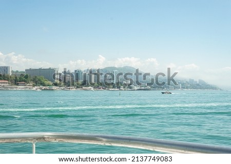 Motor ships and yachts on pier. Close-up. Wide landscape of the Black Sea. Sea trade port with mooring boats at sunset in Sochi, Russia Royalty-Free Stock Photo #2137749083