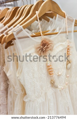 A picture of beautiful lace white dress on the hanger. 