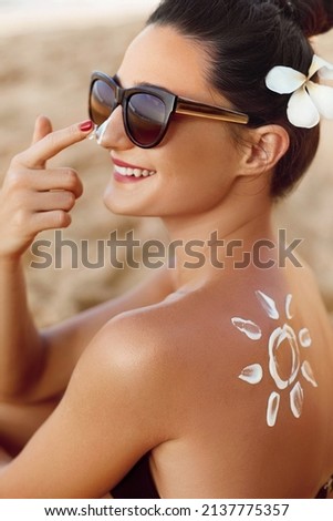 Woman smile applying sun cream  on face. Skincare. Body Sun protection. sunscreen. Female smear moisturizing lotion on skin.