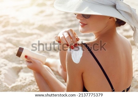 Beautiful Woman in Bikini Applying Sun Cream on Tanned  Shoulder. Sun Protection. Skin and Body Care.  Royalty-Free Stock Photo #2137775379