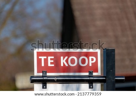 Business and marketing concept, Selective focus of advertisement for sign board with the word in Dutch "Te Koop" (For Sale in English) housing or immovable, realty, property, Netherlands. 