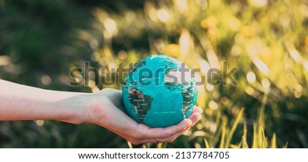 hand holding globe Earth day