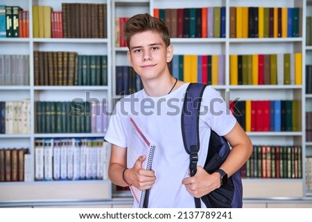 Portrait of male teenage student looking into the camera in library Royalty-Free Stock Photo #2137789241