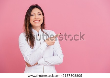 Beautiful Brazilian Caucasian woman professional beautician, cosmetologist, Photo in cluse, index finger pointing, for negative space for text or ad, promotion. Royalty-Free Stock Photo #2137808805