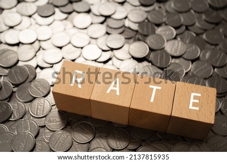 Wooden blocks with "RATE" text of concept and coins.