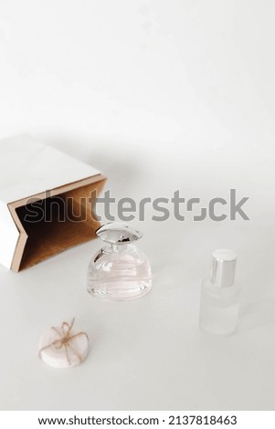 Set of body treatment with white paper bag in minimal style. Perfume, soap and blank bottle cosmetic for daily beauty and body treatment product