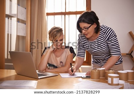 The true entrepreneur is a DOER, not just a dreamer. A cropped shot of two women working in a home office. Royalty-Free Stock Photo #2137828299