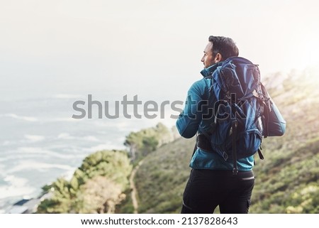 Always dare to explore the beautys nature holds. Rearview shot of a middle aged man hiking in the mountains. Royalty-Free Stock Photo #2137828643