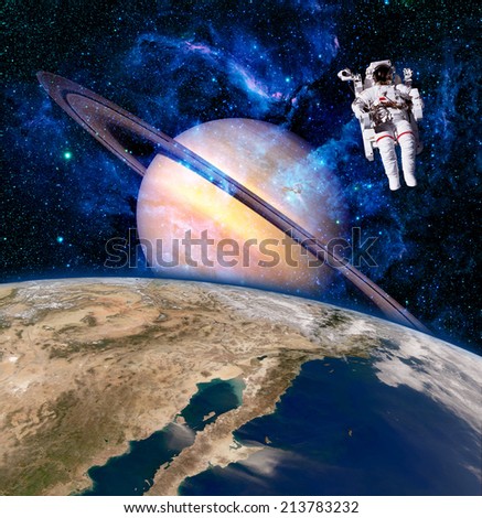 Space astronaut spaceman saturn planet surreal background. Elements of this image furnished by NASA.