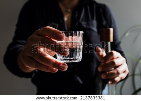 bartender hand serving mexican mezcal shot drink in a traditional glass in Mexico city Latin America

